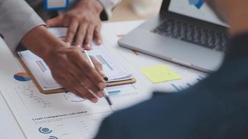 Financial analysts analyze business financial reports on a digital tablet planning investment project during a discussion at a meeting of corporate showing the results of their successful teamwork. video