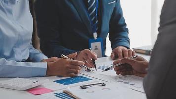 Financial analysts analyze business financial reports on a digital tablet planning investment project during a discussion at a meeting of corporate showing the results of their successful teamwork. video