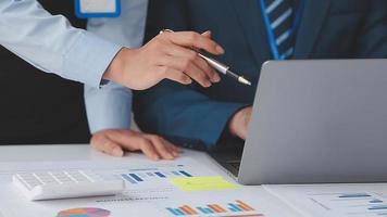 Financial analysts analyze business financial reports on a digital tablet planning investment project during a discussion at a meeting of corporate showing the results of their successful teamwork. video