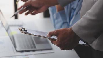 Financial analysts analyze business financial reports on a digital tablet planning investment project during a discussion at a meeting of corporate showing the results of their successful teamwork. video
