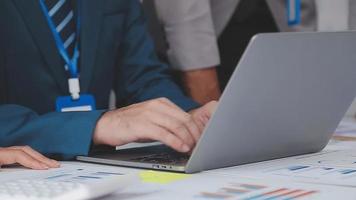Financial analysts analyze business financial reports on a digital tablet planning investment project during a discussion at a meeting of corporate showing the results of their successful teamwork. video