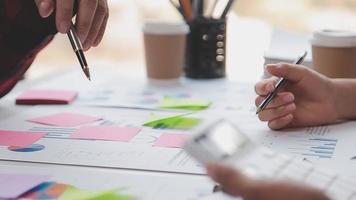 Financial analysts analyze business financial reports on a digital tablet planning investment project during a discussion at a meeting of corporate showing the results of their successful teamwork. video