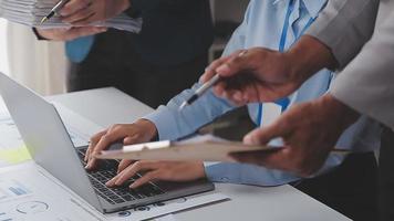 Financial analysts analyze business financial reports on a digital tablet planning investment project during a discussion at a meeting of corporate showing the results of their successful teamwork. video