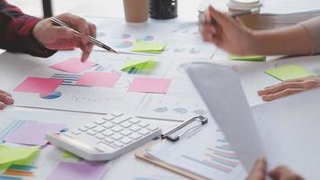 Financial analysts analyze business financial reports on a digital tablet planning investment project during a discussion at a meeting of corporate showing the results of their successful teamwork. video
