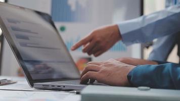 Financial analysts analyze business financial reports on a digital tablet planning investment project during a discussion at a meeting of corporate showing the results of their successful teamwork. video