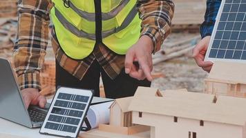 Two business man construction site engineer. Engineering objects on workplace with partners interacting on background video