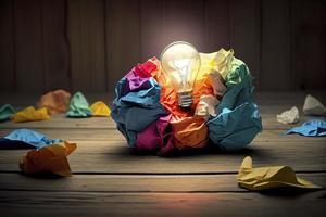 great idea concept with crumpled colorful paper and light bulb on wooden table photo