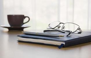 Pen and Glasses on a book photo