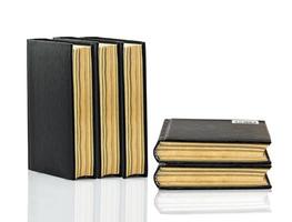 Closed black book with shadow on white background photo