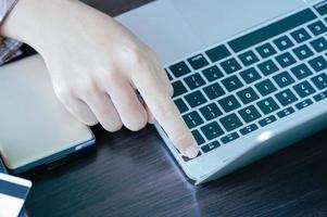 Male working with Laptop computer on the table photo