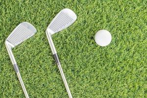 Golf club and golf ball on green grass photo