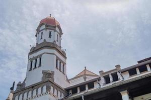 Tower on old mansion of Semarang Central Java with blue sky. The photo is suitable to use for travel destination, holiday poster and travel content media.