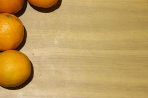 four oranges on wooden background photo