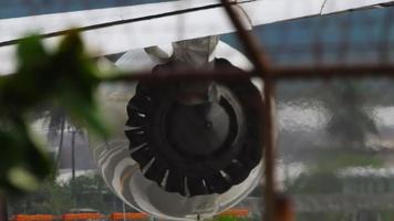 Jet engine closeup view of fan. Aircraft view through airport fence. Airplane on the runway preparing for takeoff video