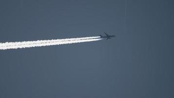Widebody airplane flying at high altitude with contrail video