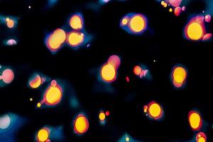 abstract bokeh background of golden light burst made from bokeh motion. photo