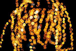 abstract bokeh background of golden light burst made from bokeh motion. photo