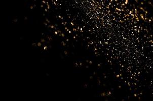 background of abstract glitter lights. gold and black. de focused photo