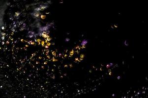 background of abstract glitter lights. gold and black. de focused photo