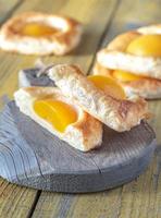 Puff pastry with canned peaches photo