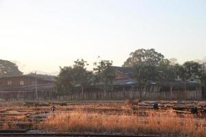 farm with sun ray window view from train on curve photo