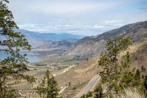 View of mountain highway and lake in the Okanagan Valley in British Columbia photo