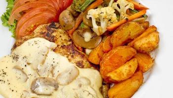 Peri peri Chicken with Button mushroom gravy, Saute Vegetables, Spicy fried Potatoes with Tomato Lettuce Salad. photo