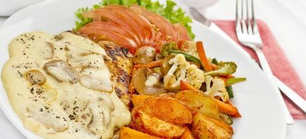 Peri peri Chicken with Button mushroom gravy, Saute Vegetables, Spicy fried Potatoes with Tomato Lettuce Salad. photo