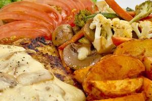 Peri peri Chicken with Button mushroom gravy, Saute Vegetables, Spicy fried Potatoes with Tomato Lettuce Salad. photo