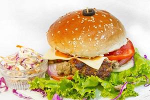 A big size Burger Patties from Ground Beef with Lettuce leaf and Coleslaw Salad. photo