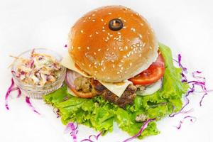 A big size Burger Patties from Ground Beef with Lettuce leaf and Coleslaw Salad. photo