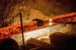 Gas cutting of the hot metal in steel plant at Demra, Dhaka, Bangladesh photo