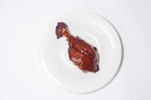 Baked chicken wings with sesame and lettuce with a plate. Top view. photo