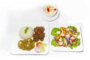 Asian style ramadan sehri food set. Healthy full course meal. A plate of green salad, A plate of plane rice and 2 kind of beef curry with Faluda dessart on white background. photo