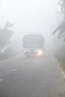 Bangladesh January 06, 2014 On a foggy winter morning, a bus is passing through the foggy streets and slows traffic at Ranisankail, Thakurgaon. photo