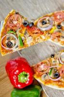 Popular colorful ingredients as like tomatoes, cheese, mushroom, capsicum, olives and other ingredients baked healthy Pizza. photo