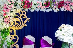 Artificial colorful paper flowers with navy-blue color based wedding stage decoration. photo