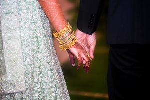 Wedding day, the bride and groom walking hand in hand. Western Wedding. photo