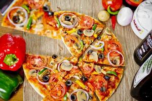 Popular colorful ingredients as like tomatoes, cheese, mushroom, capsicum, olives and other ingredients baked healthy Pizza. photo