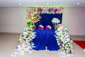 Artificial colorful paper flowers with navy-blue color based wedding stage decoration. photo