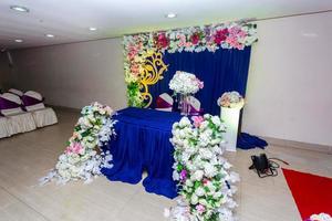 Artificial colorful paper flowers with navy-blue color based wedding stage decoration. photo