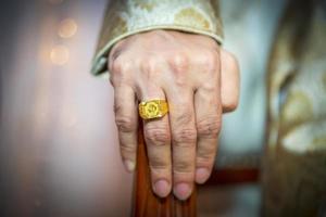 A groom's hand wearing a gold ring. Indian Wedding. photo