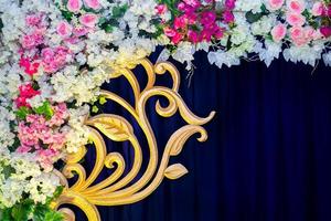 Artificial colorful paper flowers with navy-blue color based wedding stage decoration. photo