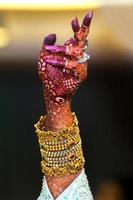 A bride's hand filled with henna and ornaments in a dance style. Indian Wedding. photo