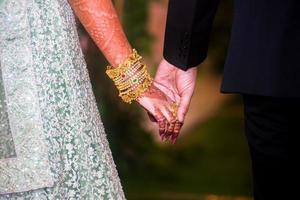 Wedding day, the bride and groom walking hand in hand. Western Wedding. photo