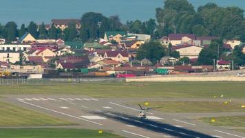 Helicopter on the airfield starts to take off, long shot. Panoramic view, airport on the background of the city video