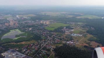 View from the plane window on the territory of the Moscow region. Fly over the city, drop for landing video
