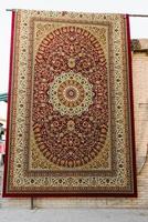 Bukhara, Uzbekistan. March 2022. Oriental carpet at the bazaar photo