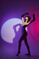 Portrait of a charming lady scene spotlight posing neon purple background unaltered photo