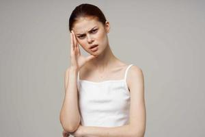 disgruntled woman holding head migraine disorder isolated background photo